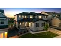 Charming two-story home boasting a covered porch, gray siding, and beautifully landscaped front yard at 359 Rogers Way, Castle Rock, CO 80104