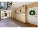 Well-lit building hallway with multiple entry doors and a decorative wreath at 1521 Vine St # 108, Denver, CO 80206