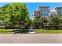 Beautiful building exterior with mature trees, manicured landscaping, and balcony views at 1521 Vine St # 108, Denver, CO 80206