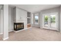 Spacious living room features a fireplace, balcony access and neutral carpeting at 1521 Vine St # 108, Denver, CO 80206