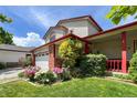 Beautiful two-story home with brick accents, a colorful flower garden, and a well-maintained green lawn at 2912 Lake Park Way, Longmont, CO 80503