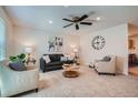 Spacious living room features plush seating, neutral tones, and a modern ceiling fan at 907 Stein St, Lafayette, CO 80026