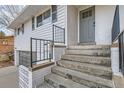 Welcoming home entrance featuring concrete steps and black railings, enhancing curb appeal at 11870 Tabor Dr, Lakewood, CO 80215