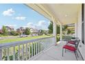 Relaxing front porch with white railings, chairs, and a view of the neighborhood at 7902 E 49Th Pl, Denver, CO 80238