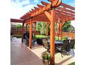 Relaxing backyard patio with pergola, table, chairs, and grill at 580 Mount Massive St, Berthoud, CO 80513