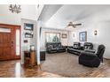 Bright living room with hardwood floors, fireplace, and leather seating at 580 Mount Massive St, Berthoud, CO 80513