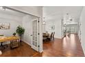 Open entryway with hardwood floors leading to the formal dining room and living area at 1822 Painter Dr, Monument, CO 80132
