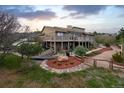 Stunning backyard with a large deck, mature trees, and landscaped yard at 440 Scrub Oak Cir, Monument, CO 80132