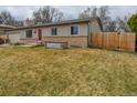 Home exterior showcasing the lawn and brick features that adds texture and character at 11964 W 71St Pl, Arvada, CO 80004