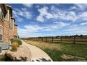 Nice backyard view, featuring a fence and green space with an adjacent sidewalk at 3155 Blue Sky Cir # 16-103, Erie, CO 80516