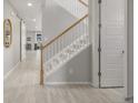 Bright foyer with a white staircase and a coat closet with a barn door at 4925 Coltin Trl, Castle Rock, CO 80104