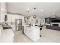 Open-concept kitchen featuring stainless steel appliances, a white island and hardwood floors at 4925 Coltin Trl, Castle Rock, CO 80104