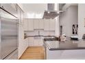 Contemporary kitchen with stainless steel appliances, sleek countertops, and custom cabinetry at 1521 Central St # 3C, Denver, CO 80211