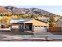 Inviting single-Gathering home with stucco and stone accents, set against a backdrop of picturesque mountains at 91 Greeley Blvd, Palmer Lake, CO 80133