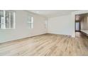 Bright living room features wood-look floors and large windows at 6634 N Malta St, Aurora, CO 80019