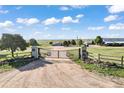 Grand entrance gate leading to a sprawling estate with lush landscapes and scenic views at 1705 Outter Marker Rd, Castle Rock, CO 80108