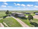 Charming home with a long driveway, complemented by picturesque green surroundings at 1705 Outter Marker Rd, Castle Rock, CO 80108