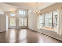 Bright living room features hardwood floors, high ceilings, and large windows for ample natural light at 9422 E 58Th Pl, Denver, CO 80238