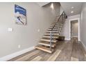 Modern staircase with wood steps, black metal railings, and light wood floors creating a stylish interior at 436 N Fuller Placer Rd, Breckenridge, CO 80424