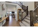 Grand foyer showcases a sweeping staircase, hardwood floors, and an open floor plan flowing into the living room at 10167 Nadine Ave, Parker, CO 80134