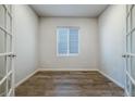Versatile office space with neutral walls, a window with blinds, and stylish wood flooring at 8609 Cheraw St, Littleton, CO 80125