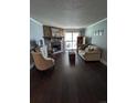 Inviting living room with stone fireplace, hardwood floors, and sliding glass doors to outdoor space at 1863 S Pitkin Cir # B, Aurora, CO 80017