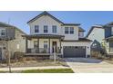 Charming two-story home with a welcoming front porch and a well-maintained lawn at 2840 E 102Nd Pl, Thornton, CO 80229