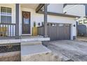 Inviting front porch and door featuring a wreath, potted greenery, and a view of the front yard at 2840 E 102Nd Pl, Thornton, CO 80229