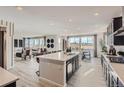 Open-concept kitchen with an island, and an adjacent living/dining area with abundant natural light and stylish design at 14123 Bunny Hop Ln, Parker, CO 80134