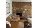 Cozy living room boasts a brick fireplace, comfortable seating, and warm, inviting decor for relaxation at 155 S Pennsylvania St # 209, Denver, CO 80209