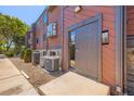 Condo entrance featuring modern siding, a gray door, and a concrete entryway at 303 W Lehow Ave # 22, Englewood, CO 80110