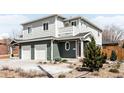 Two-story home showcasing a two-car garage, well-manicured landscaping, and inviting entrance at 3402 N Clayton St, Denver, CO 80205