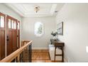 Bright foyer with hardwood floors, stylish console table, and natural light through an octagon window at 3402 N Clayton St, Denver, CO 80205
