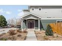 Inviting home featuring a well-maintained lawn, covered porch, and modern front door at 3402 N Clayton St, Denver, CO 80205