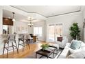 Open-concept living area with a breakfast bar, dining space, and comfortable seating area at 3402 N Clayton St, Denver, CO 80205