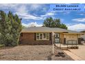 Charming single-story brick home with manicured landscaping and inviting entryway, lender credits available at 2692 S Osceola St, Denver, CO 80219
