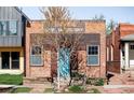Front exterior view of a brick building, showing the building's unique architecture and landscaping at 3733 N Franklin St, Denver, CO 80205
