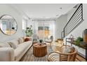 Sunlit living room features modern furnishings, hardwood floors, and sliding glass doors to the outdoor patio space at 4440 Tennyson St # 4, Denver, CO 80212