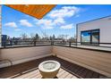 Rooftop patio with fire pit and views of the city skyline, creating an ideal space for relaxing and entertaining at 4440 Tennyson St # 4, Denver, CO 80212