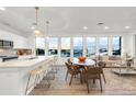 Open concept dining area with wood table and chairs, adjacent to kitchen at 2899 W 52Nd Ave # 201, Denver, CO 80221