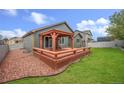 Large backyard featuring a spacious deck with a pergola perfect for outdoor entertaining at 1694 Jennifer St, Brighton, CO 80601