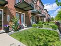 Brick townhomes with balconies and lush front lawns offer an inviting and picturesque setting at 4181 W 118Th Pl, Westminster, CO 80031