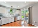 Bright kitchen featuring white cabinets, stainless steel appliances, and access to the backyard at 19523 E Buchanan Pl, Aurora, CO 80011