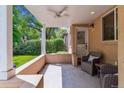 Covered front porch with ceiling fan, seating area, and view of the landscaped front yard at 1459 S Elizabeth St, Denver, CO 80210