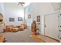Open-concept living room featuring tall ceilings, large windows with shutters, and comfortable leather seating at 3865 Rawhide Cir, Castle Rock, CO 80104