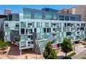 Contemporary building with sleek architecture, large windows, and vibrant landscaping provides urban living at its finest at 55 W 12Th Ave # 510, Denver, CO 80204