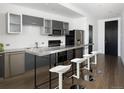 Contemporary kitchen features a stainless steel island, gray cabinets and stainless steel appliances at 55 W 12Th Ave # 510, Denver, CO 80204