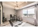 Cozy dining area with a bistro set, decorative chandelier, and window view at 7865 E Mississippi Ave # 602, Denver, CO 80247