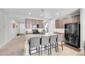 Well-appointed kitchen with stainless steel appliances, granite countertops, and a functional breakfast bar at 9635 Bellaire Ln, Thornton, CO 80229