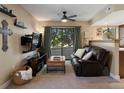 Comfortable living room with natural light, cozy seating, and a serene view of the trees outside at 12476 W Nevada Pl # 106, Lakewood, CO 80228